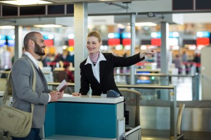 airline-check-attendant-showing-direction-commuter-check-counter_107420-95790
